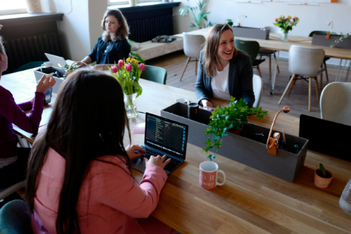 4 people are networking around a table