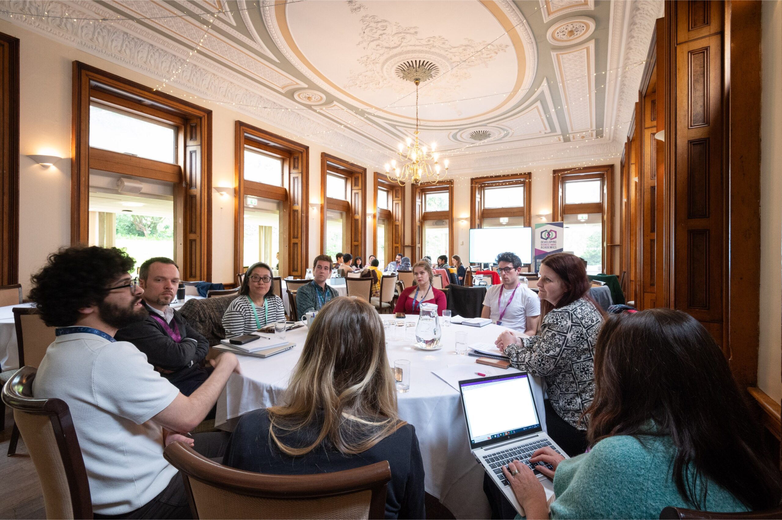 A round table discussion of 9 people at the Developing Business-Aware Academics launch event