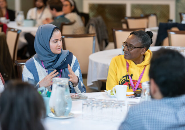 A photo of two researchers having a discussion at a round table session